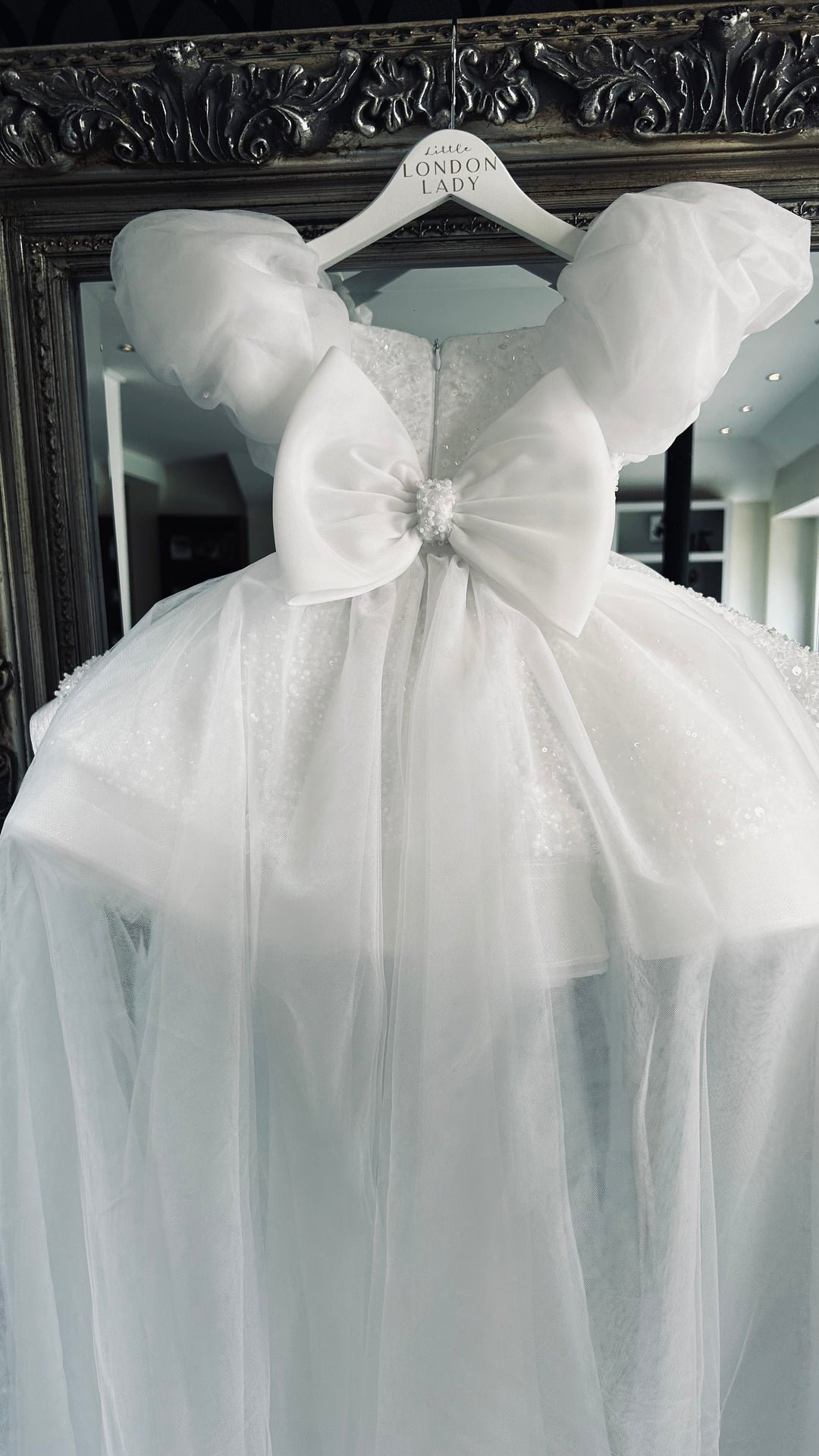 Aleena Children’s dress with long bridal train. In white sparkle glass beads and sequins. Perfect for as a christening dress, flower girls dress, baptism outfit, communion dress.