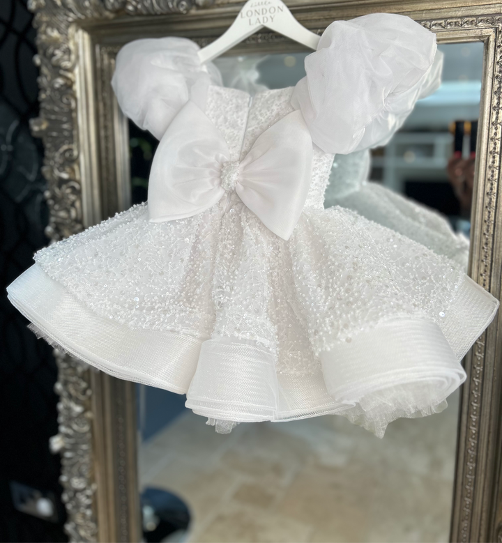 Aleena Children’s dress with long bridal train. In white sparkle glass beads and sequins. Perfect for as a christening dress, flower girls dress, baptism outfit, communion dress.
