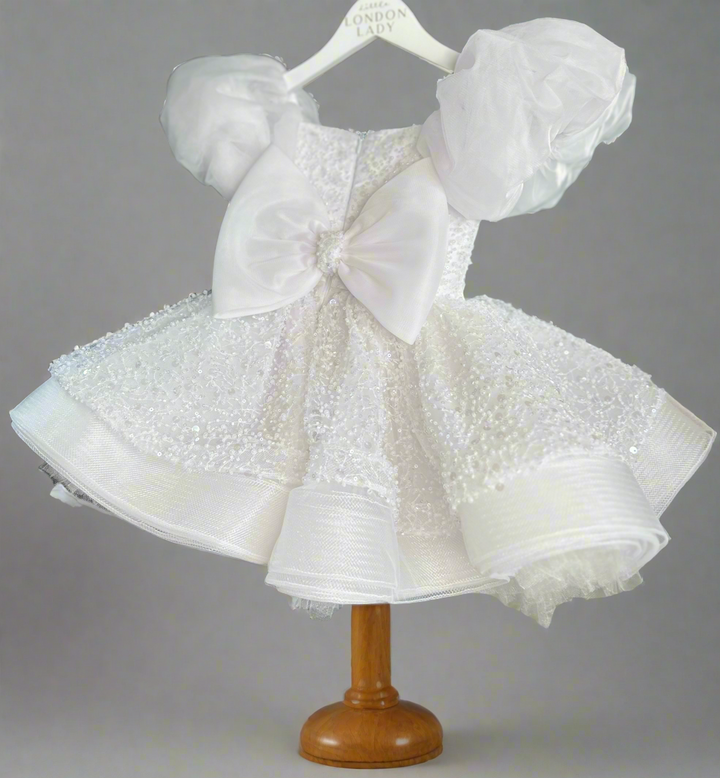 Aleena Children’s dress with long bridal train. In white sparkle glass beads and sequins. Perfect for as a christening dress, flower girls dress, baptism outfit, communion dress.
