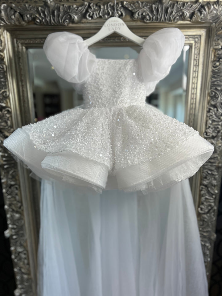 Aleena Children’s dress with long bridal train. In white sparkle glass beads and sequins. Perfect for as a christening dress, flower girls dress, baptism outfit, communion dress.