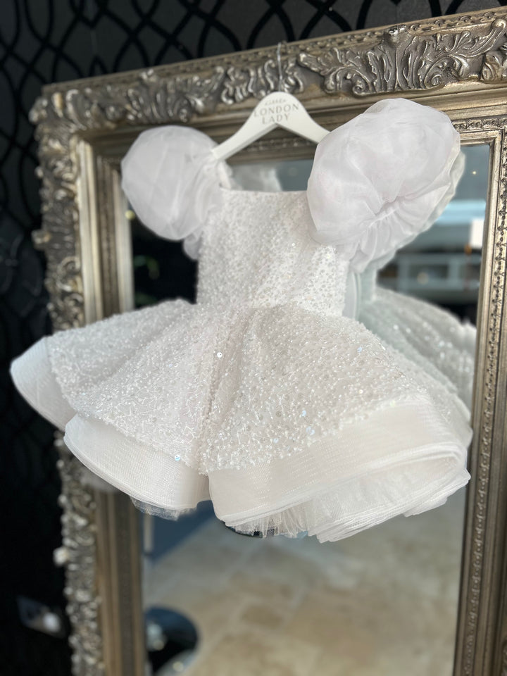 Aleena Children’s dress with long bridal train. In white sparkle glass beads and sequins. Perfect for as a christening dress, flower girls dress, baptism outfit, communion dress.