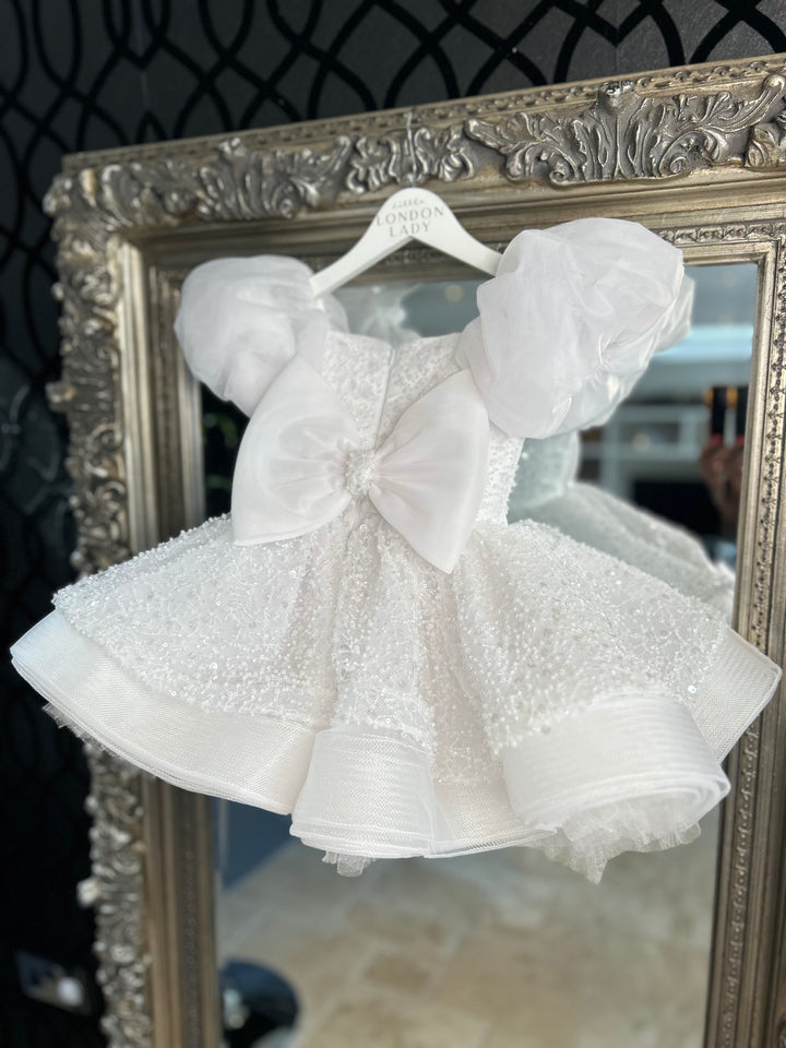 Aleena Children’s dress with long bridal train. In white sparkle glass beads and sequins. Perfect for as a christening dress, flower girls dress, baptism outfit, communion dress.