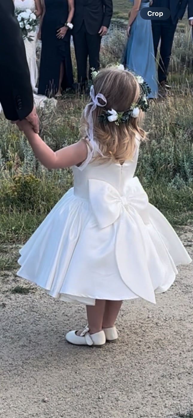 White satin flower girl dress. Little girl. Wedding.