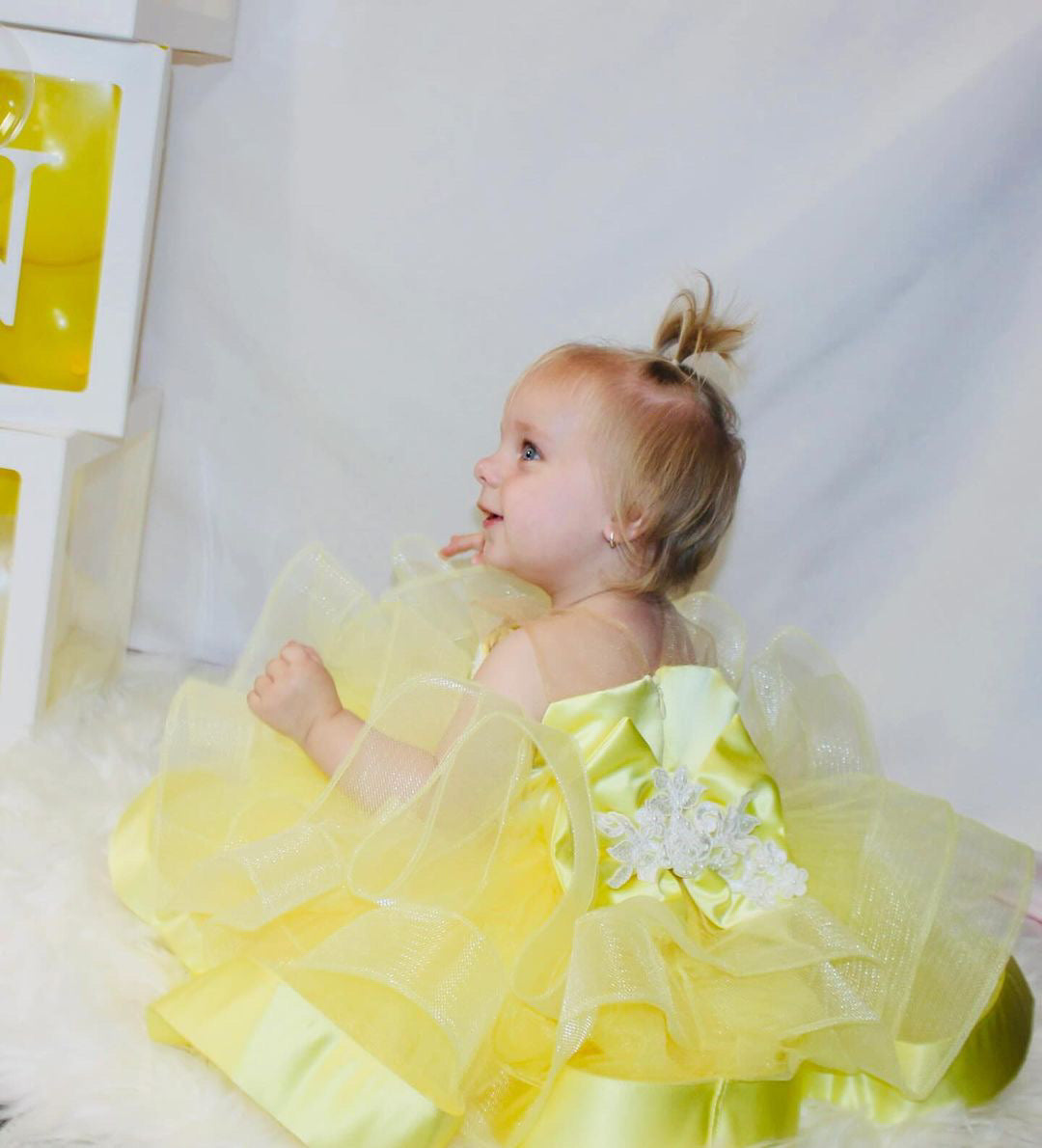 Baby dress in lemon satin with pearl embellishments.