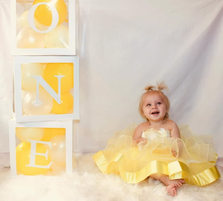 luxury 1st birthday dress in lemon yellow. The English Rose in Lemon satin.