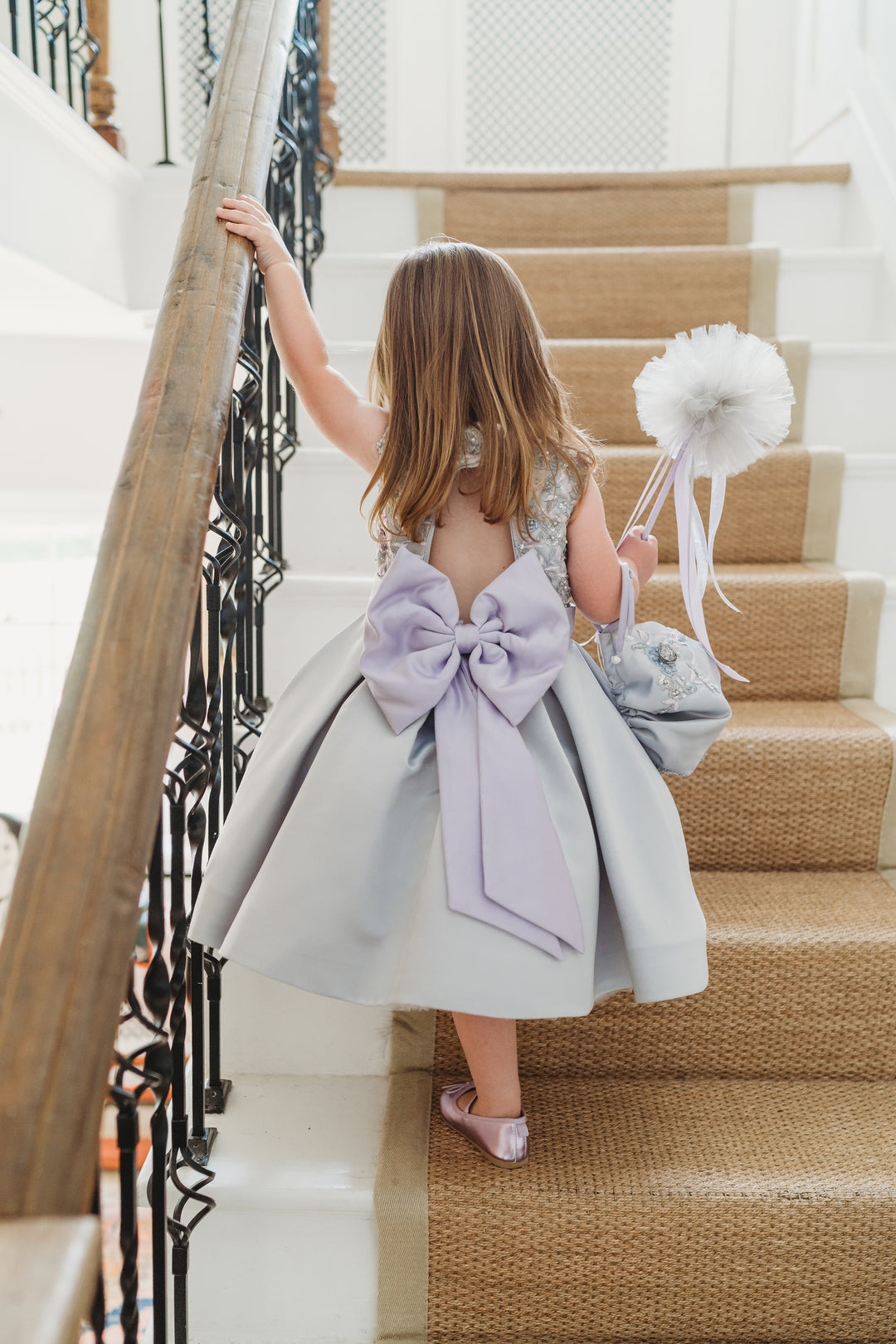 The Whoops a Daisy luxury grey satin dress with lilac satin Bow. Pom Pom wand in Lavender.