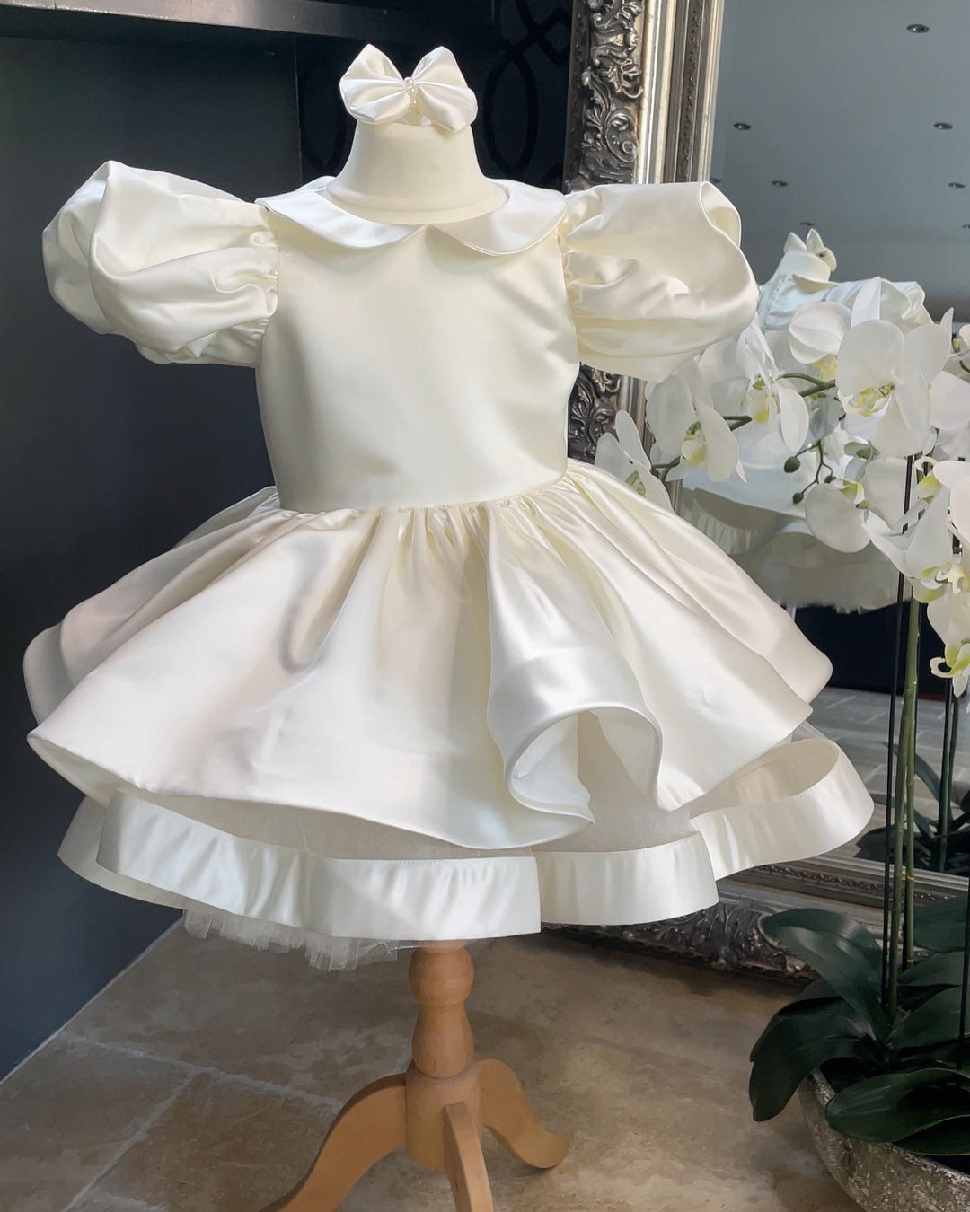 The Valentina Satin Dress in Ivory with beautiful Satin puff sleeve and classic Peter Pan collar. Full Satin Skirt with Satin trim with lots of Volume and Tulle underskirt Petitcoat.