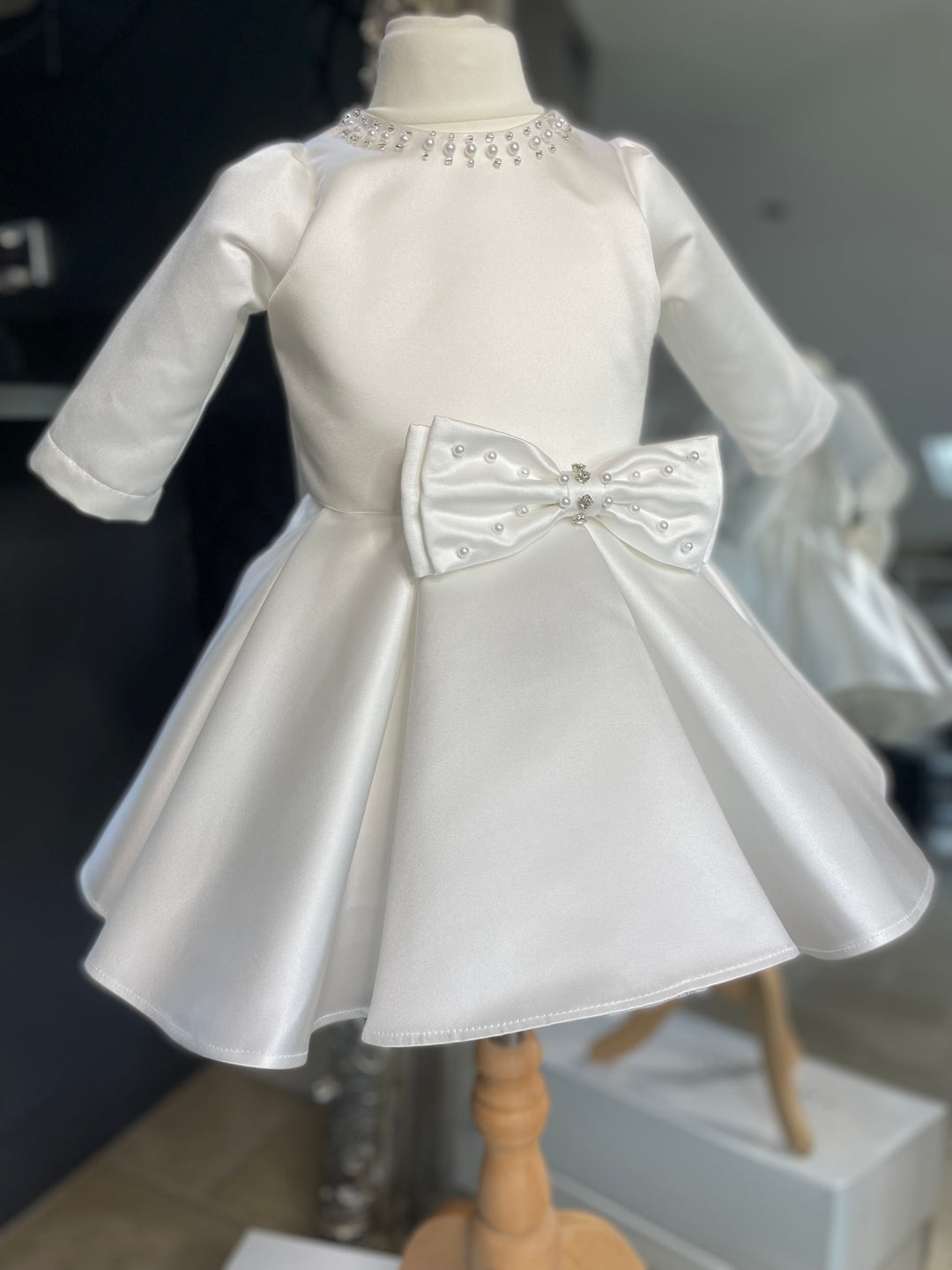 The Sofia Dress in Ivory White Satin. The Perfect baptism or christening dress. fully lined for comfort. Long Satin sleeves.