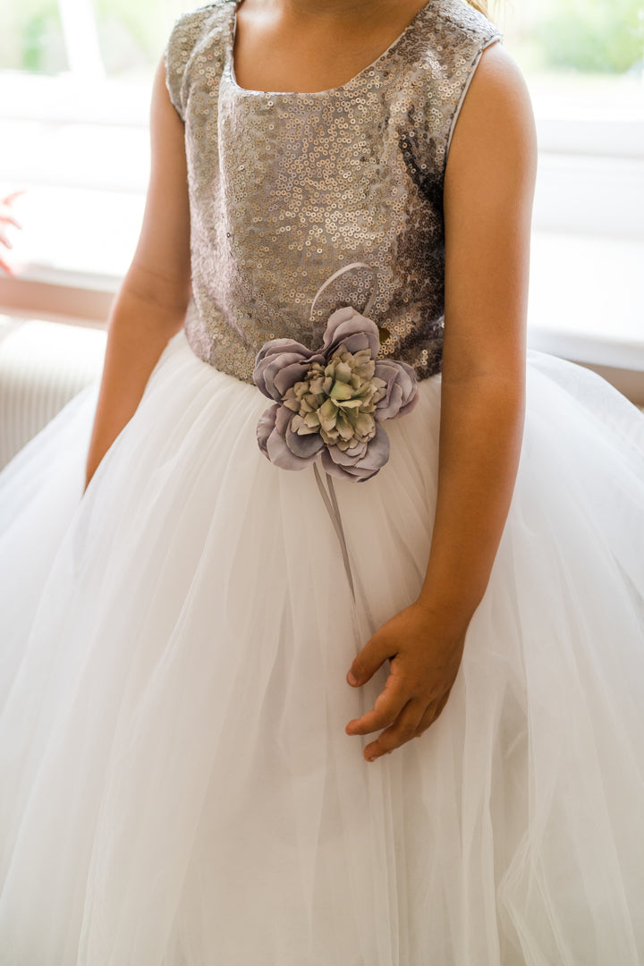 The City Shimmer childrens dress with Silver Sequin Bodice and adjustable straps. A line white tulle skirt and oversized white satin bow and tails at the back. This dress is perfect for Flower girls, little bridesmaids, pageants, wedding guest, birthday parties or any special occasion in your social calendar.
