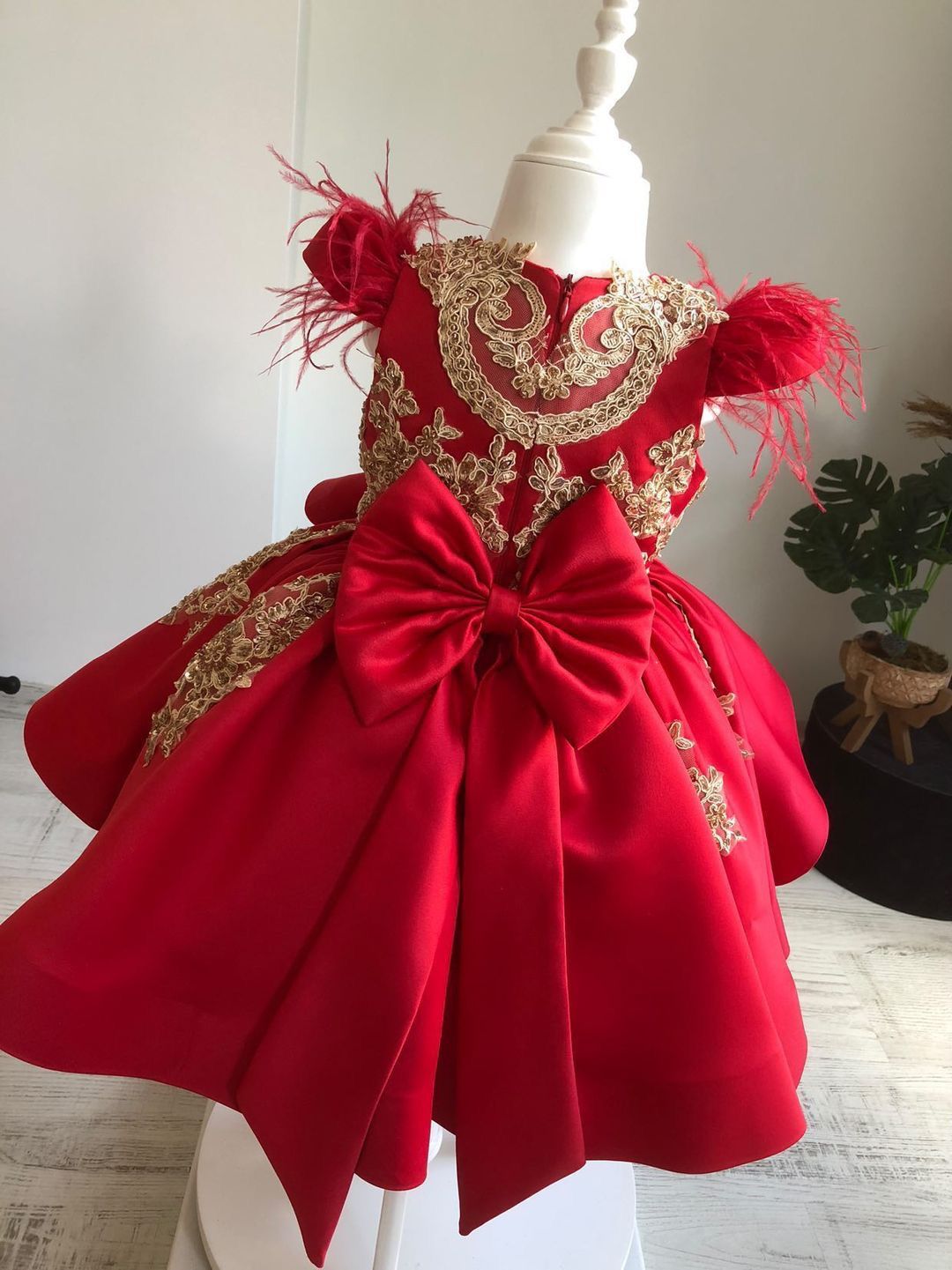 Short Custom Couture Flower girl Dress. Luxury Maroon Satin and Gold 3D Lace Appliques with beautifiul Feather Sleeves Designed for a client in the UK.