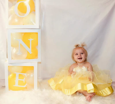 luxury 1st birthday dress in lemon yellow. The English Rose in Lemon satin. 