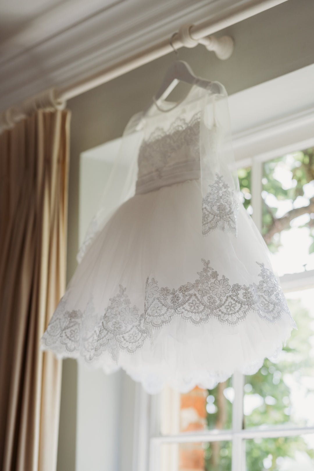 Made to perfection for a little girl who loves to be impeccably dressed. White Lace Long Sleeve Christening or  baptism dress, Long Lace embelished with Sequins Sleeve, White Tulle Skirt with huge volume and lots of layers. Comes in lots of colurs.  Silver rhinestone Tiara and white Pom Pom wand with Silver Ribbons. Photographs like a dream and the Lily is such a heirloom piece to hand down to the next generation.
